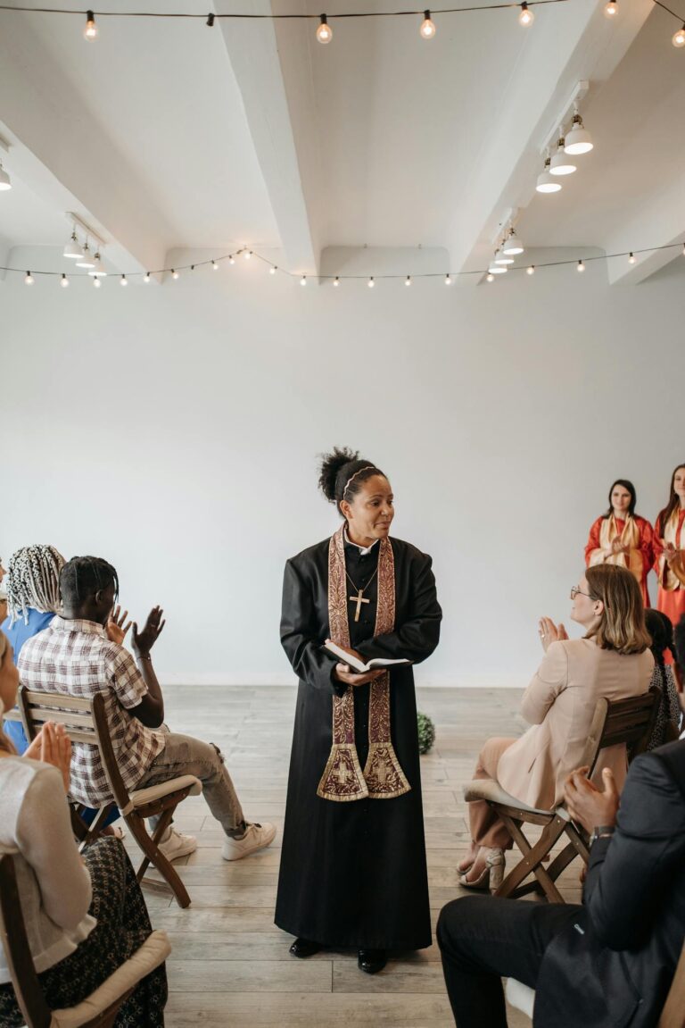 Female pastor leading a diverse congregation in an indoor church setting, fostering unity and spirituality.